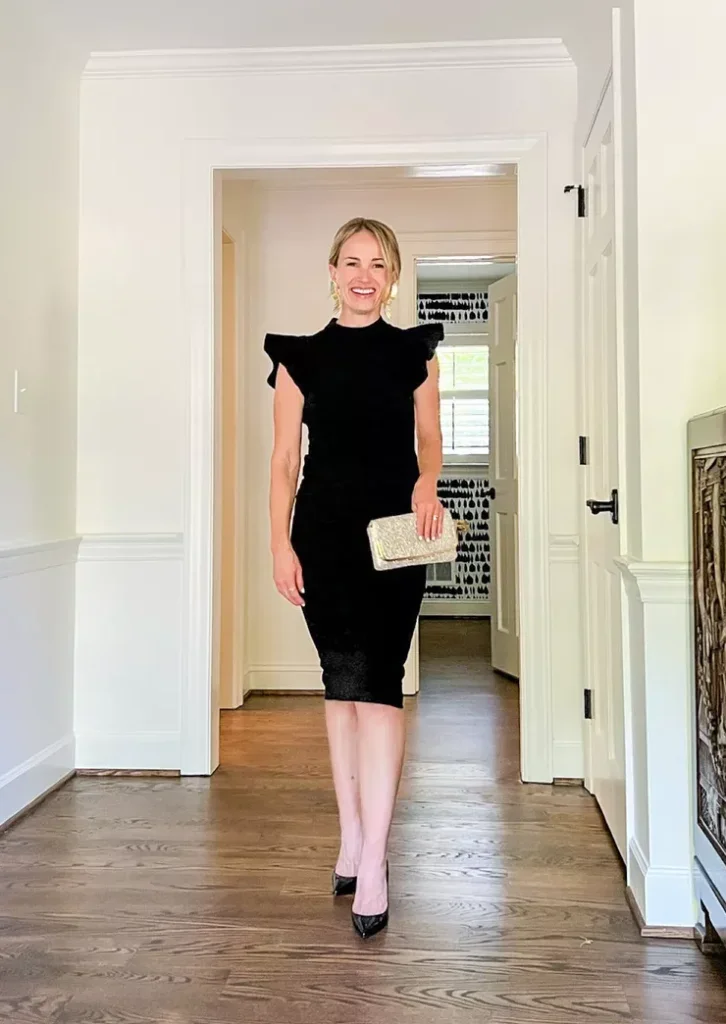 TeriLyn Adams showing the front details of her Stylish Splendor Black Backless Ruffle Bodycon Midi Dress