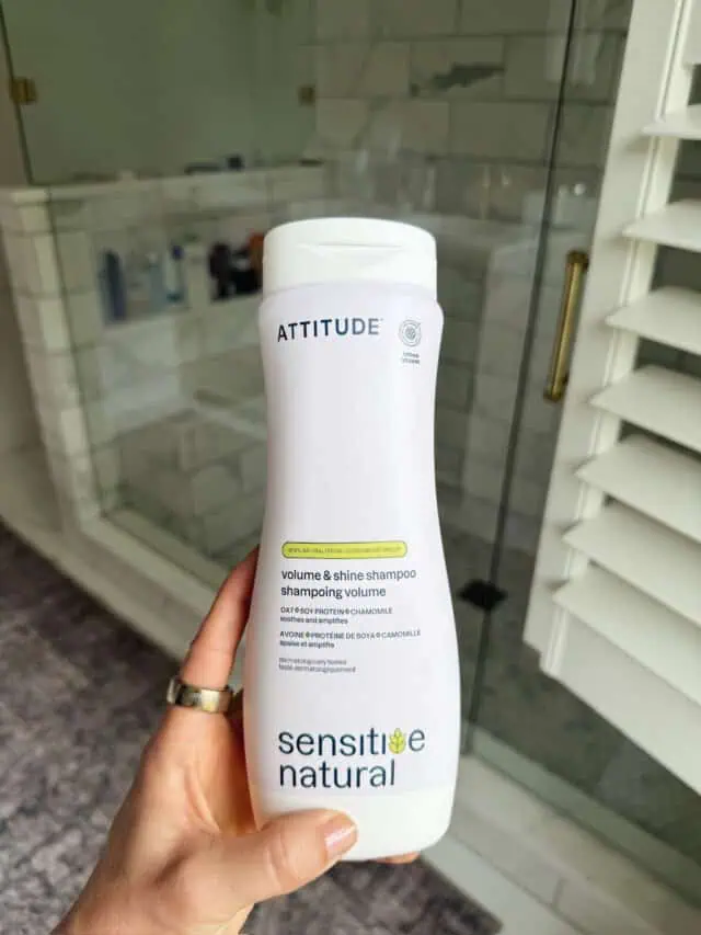 Woman holding shampoo bottle