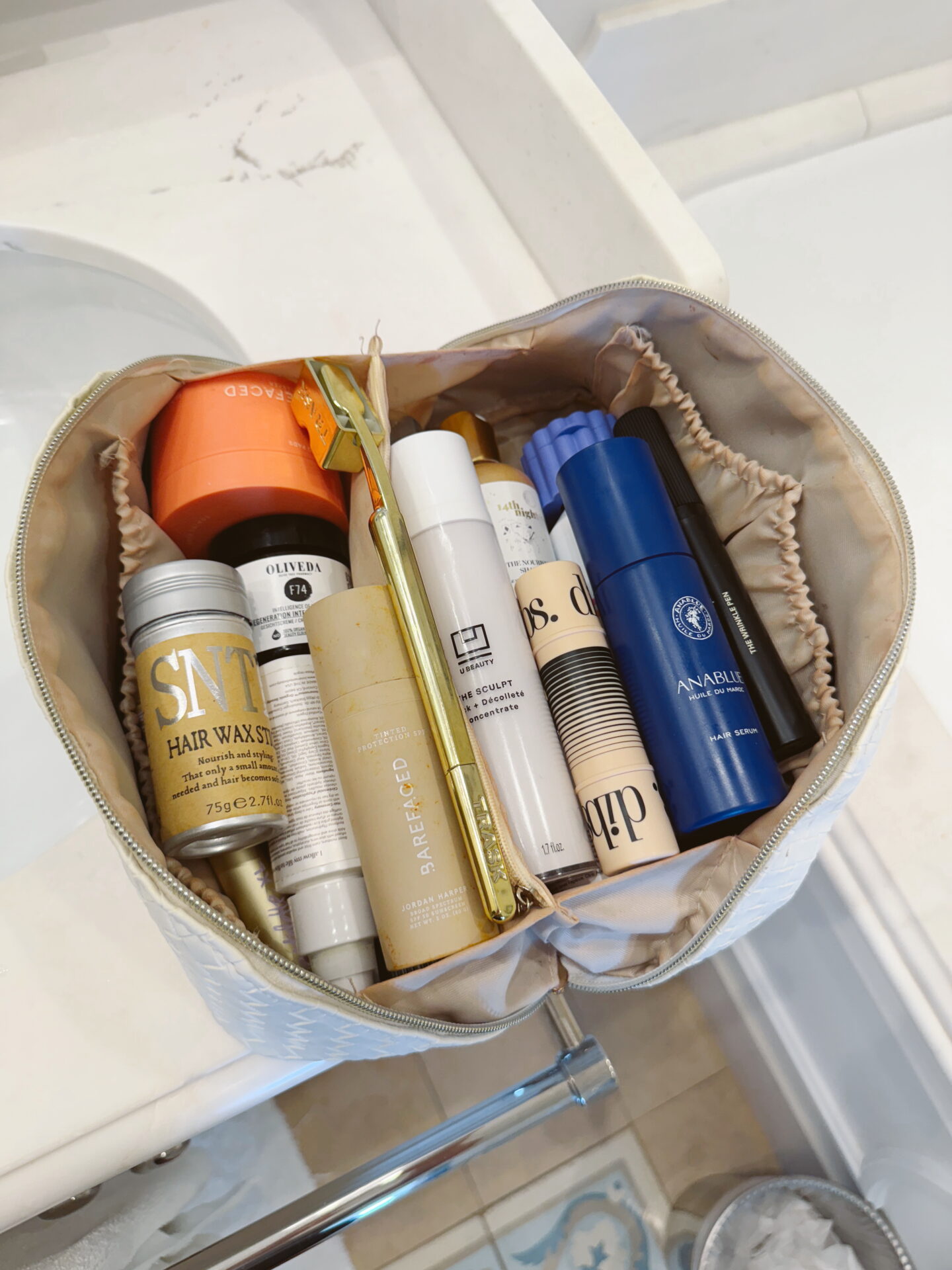 Eachy toiletry bag full with products on bathroom counter for amazon prime beauty deals.