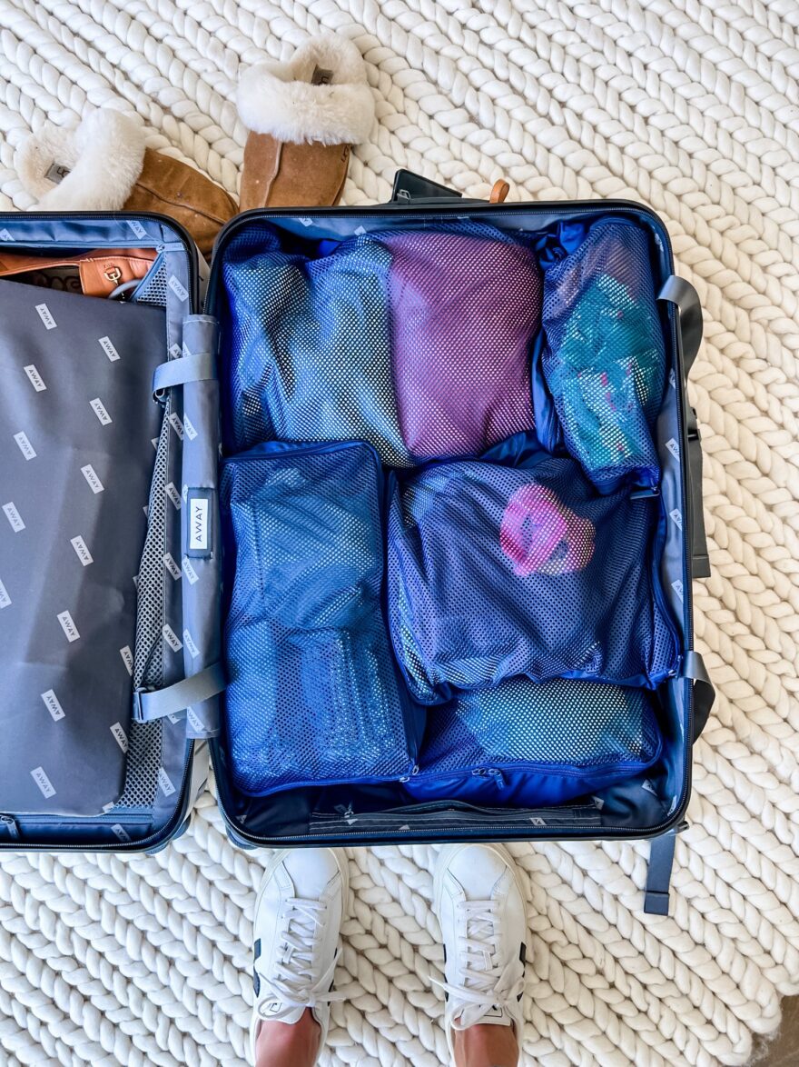 TeriLyn Adams showing how to use packing cubes in a suitcase