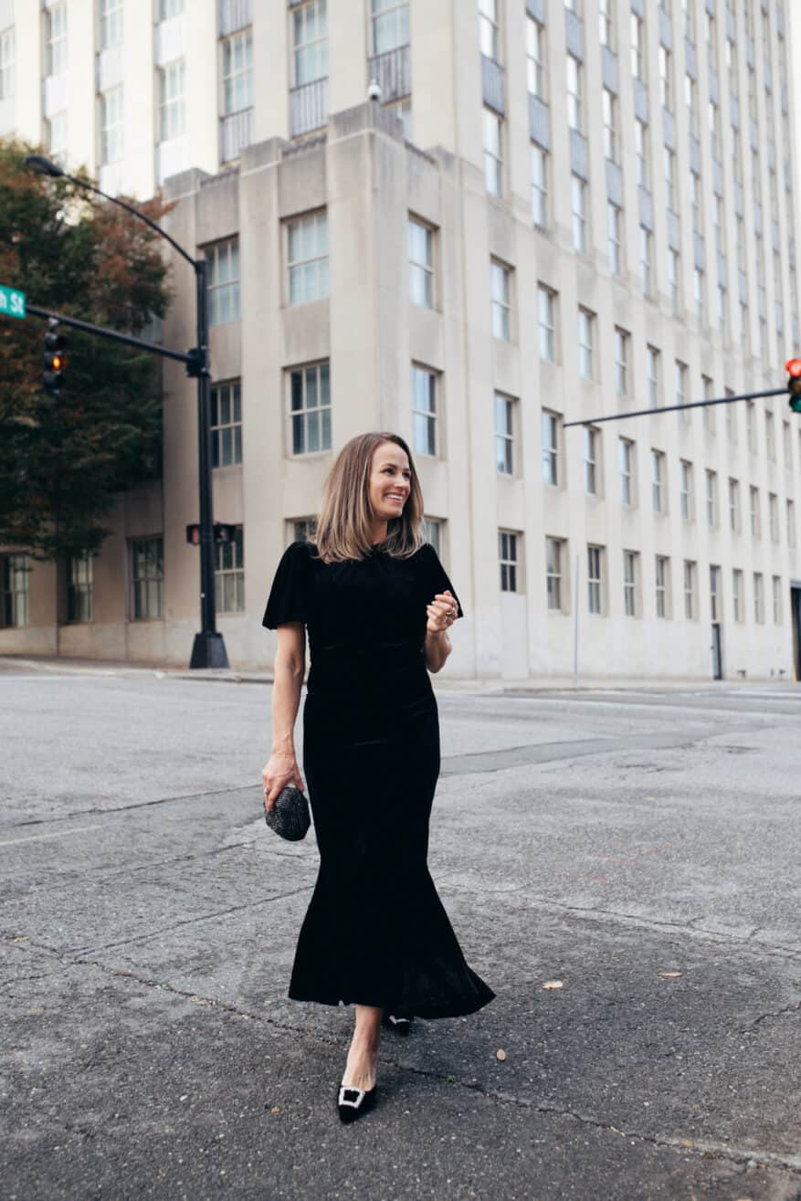 What to wear to a Holiday work party: Woman wearing velvet Elodie Dress from Tuckernuck