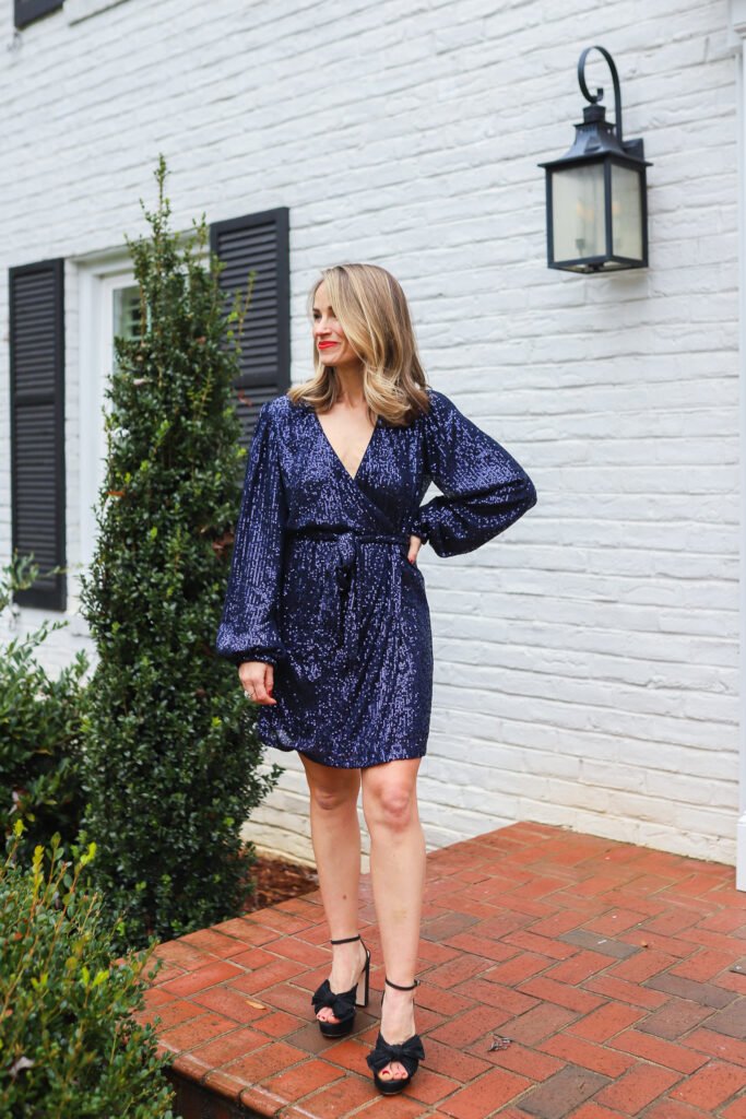 woman wearing Sparkly Darling Navy Blue Sequin Long Sleeve Wrap Dress