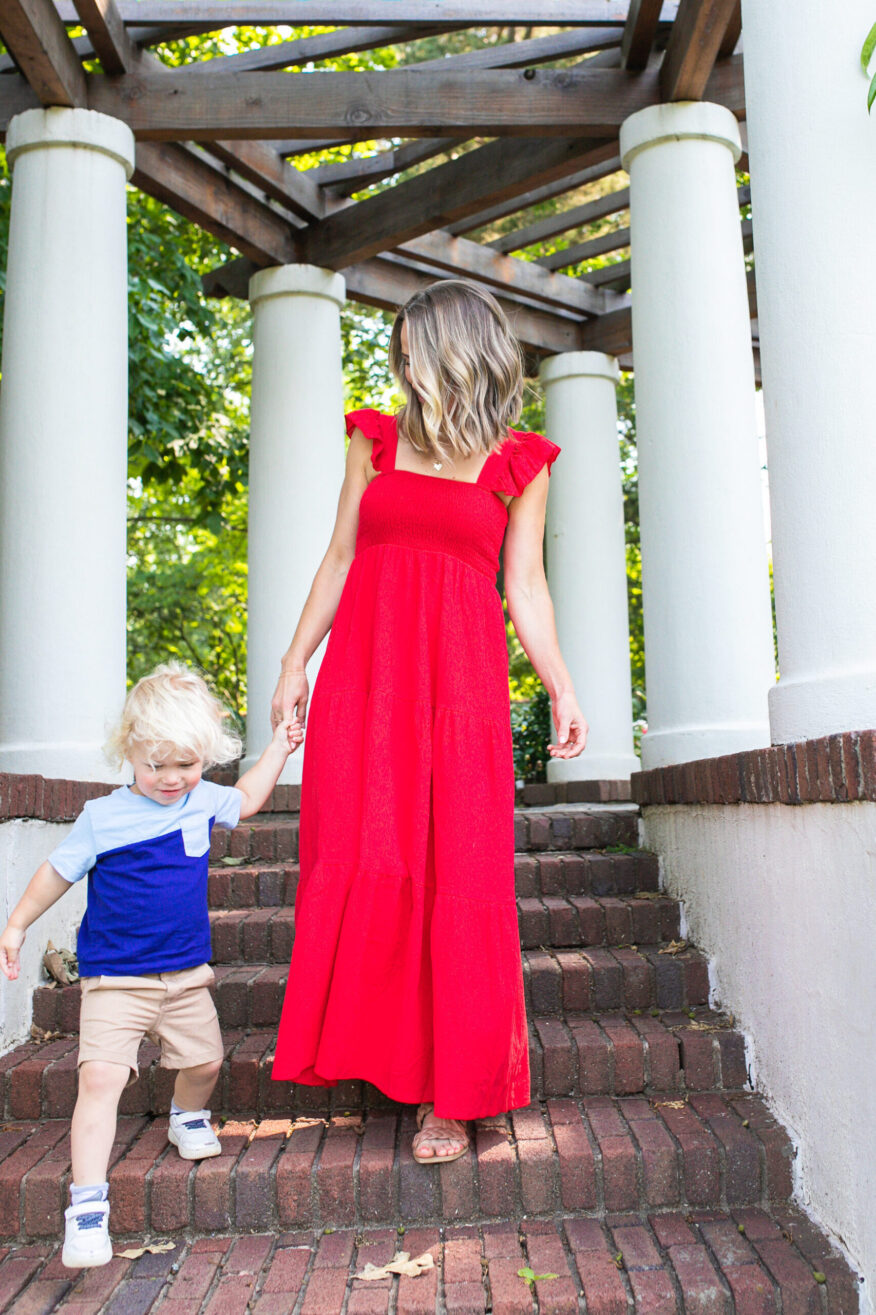 TeriLyn Adams wearing Amazon Red Smocked Maxi Dress and walking with her son