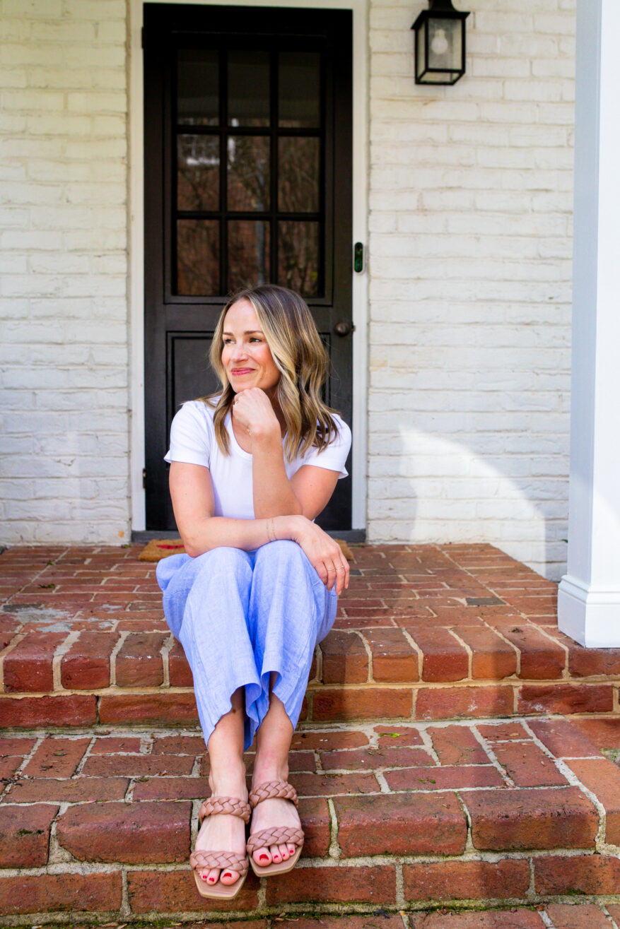 TeriLyn Adams wearing flowy silhouettes for styling tips for hot weather and sitting on the porch 