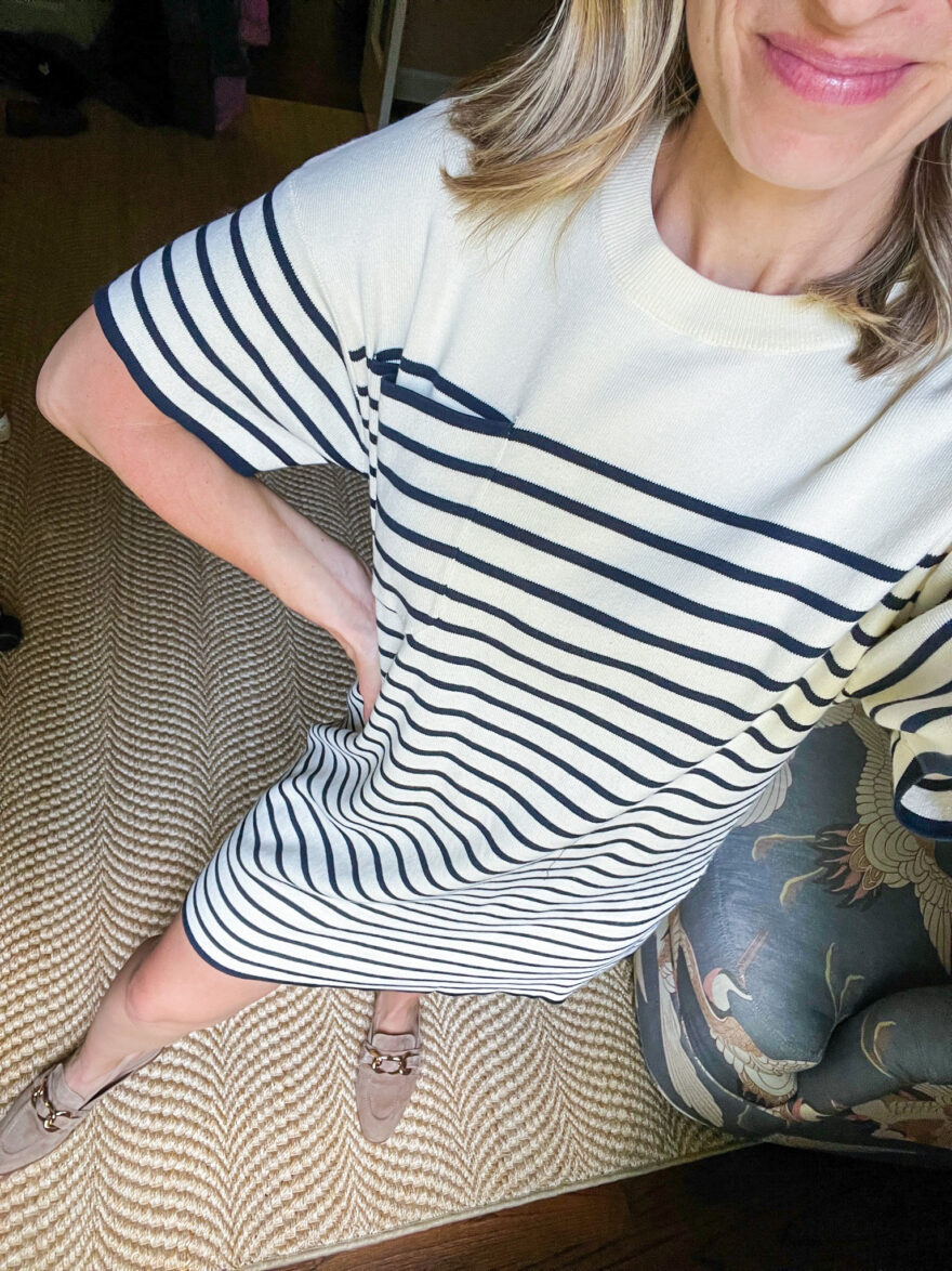 woman showing the details of her Navy Knit Striped Frenchie Dress