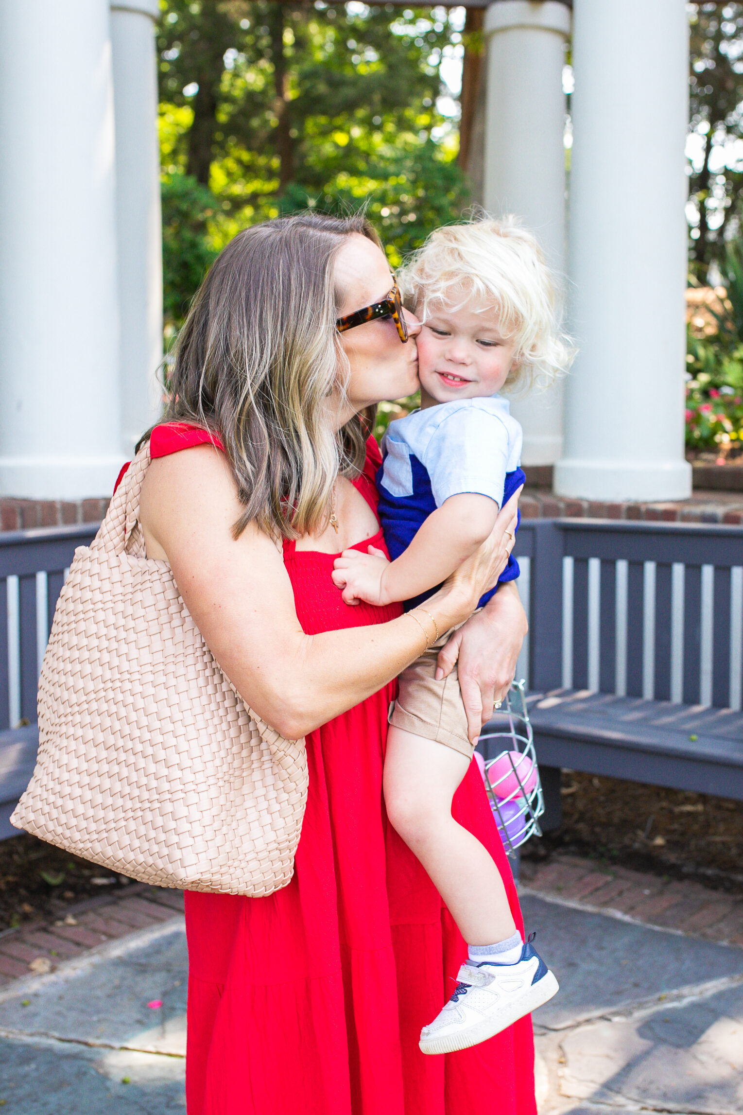woman kissing her child and wearing a red dress one of her cute 4th of July outfits