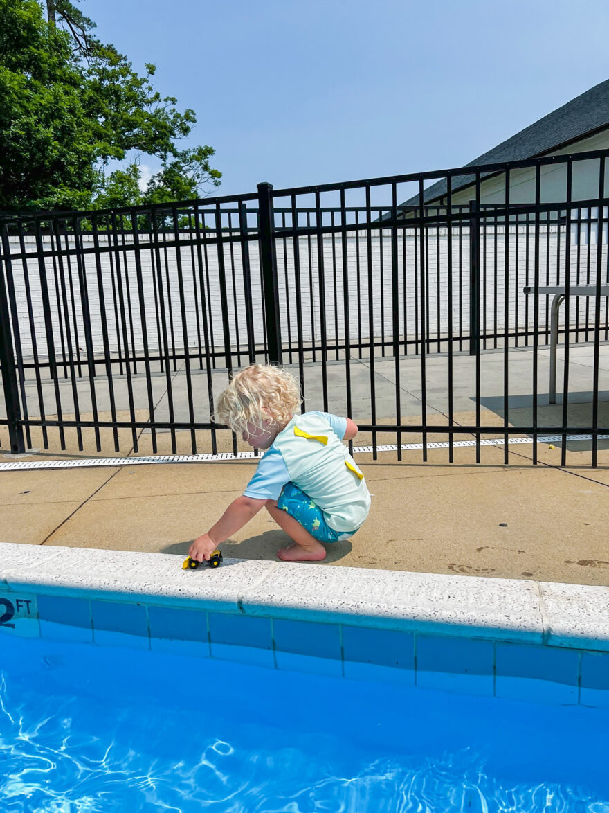 child playing at the poolside