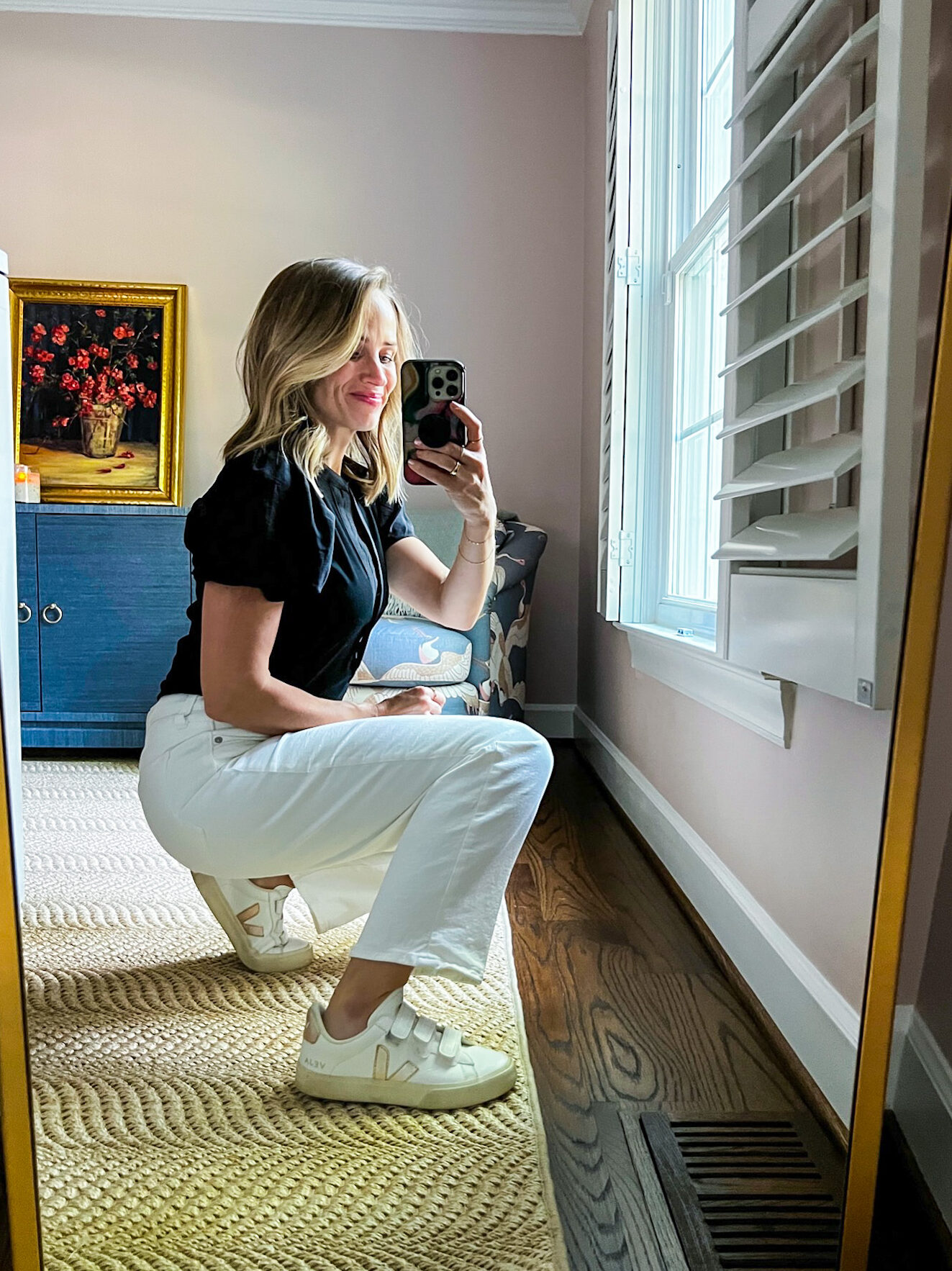 TeriLyn Adams showing details of her Veja sneakers and White Jeans