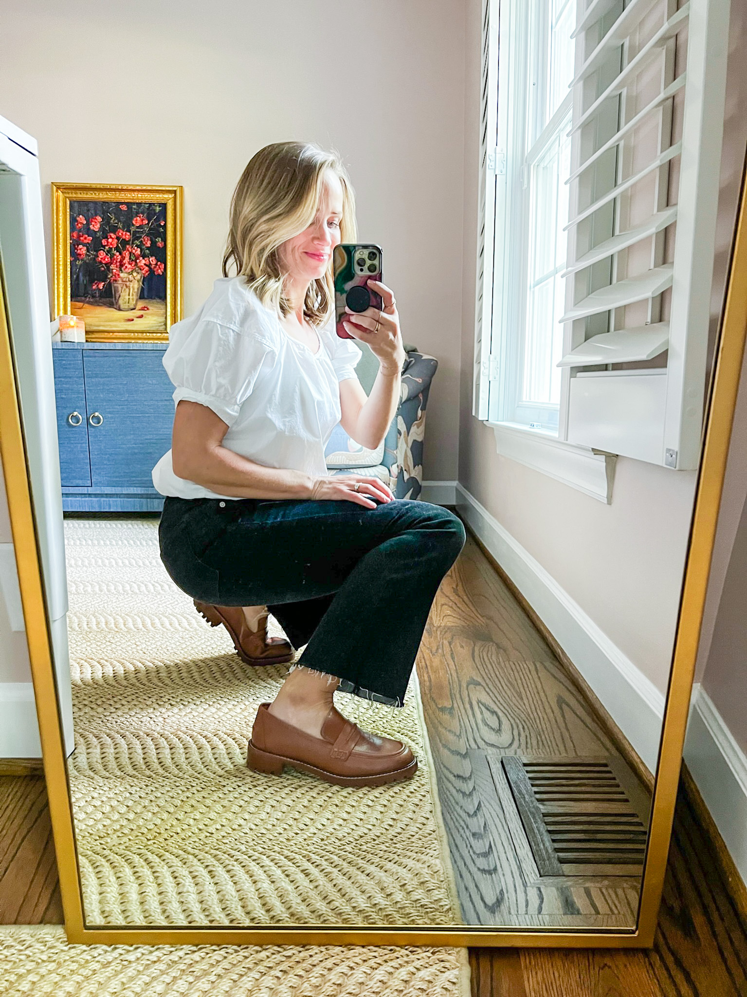 TeriLyn Adams wearing lugsole loafers with dark denim and a white blouse