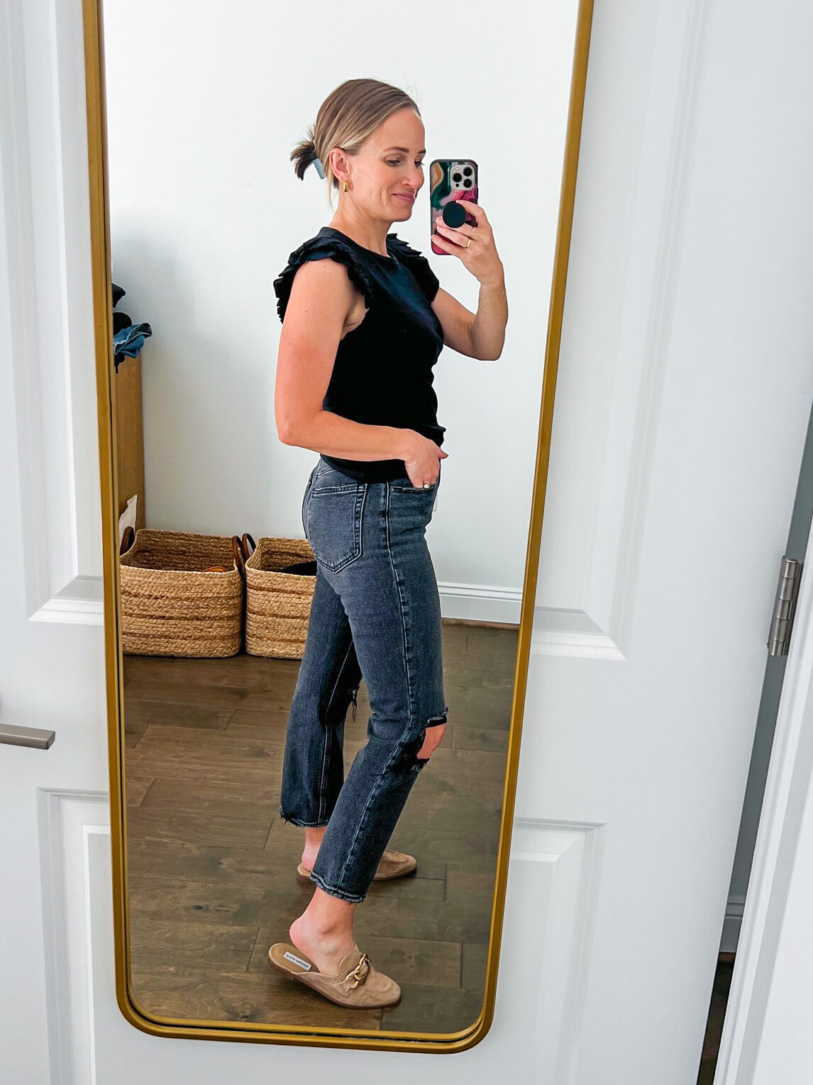TeriLyn Adams showing the side details of the Abercrombie and Fitch Ultra High-Rise Ankle Straight Jean in black distressed