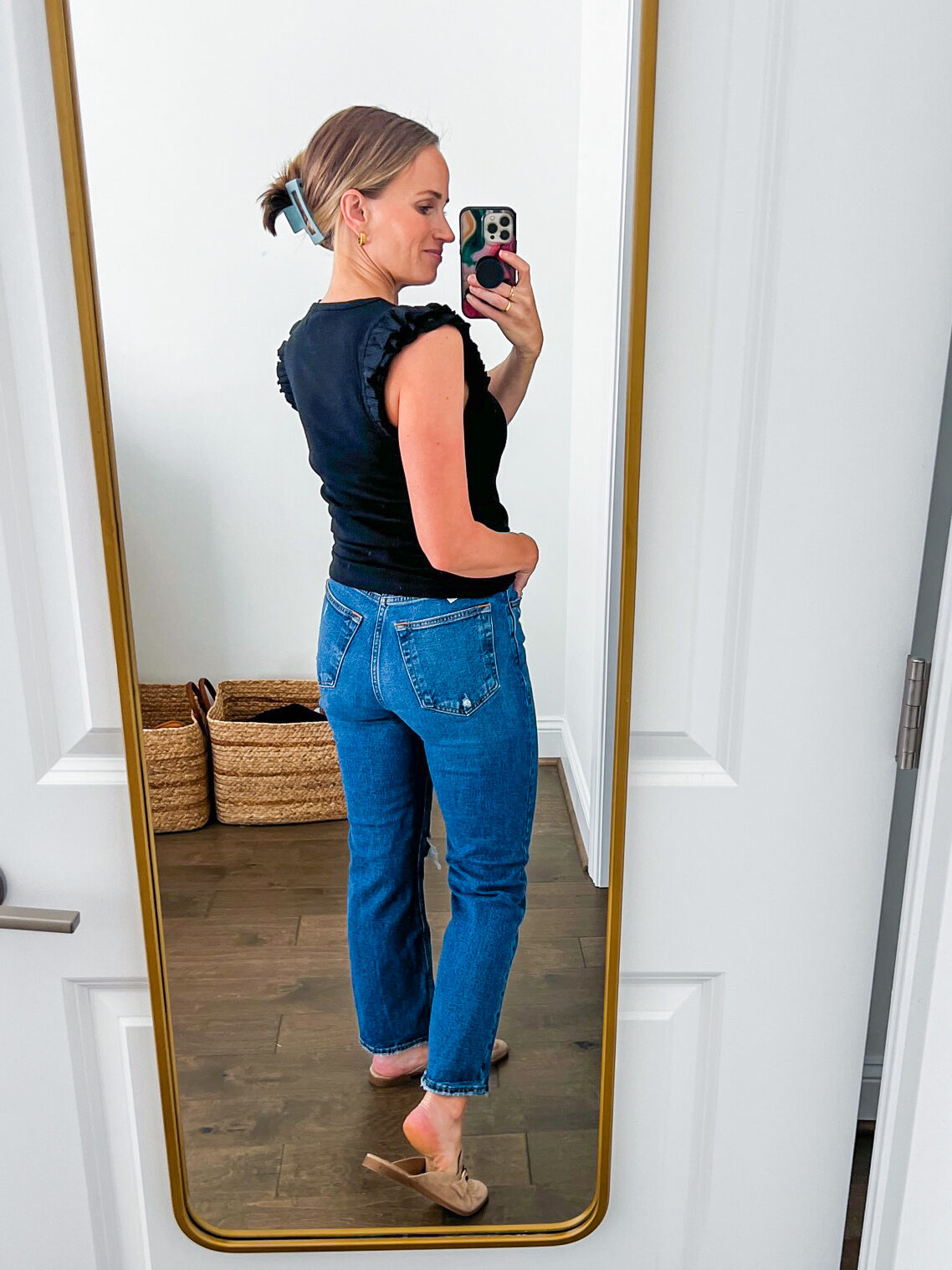 woman showing the back details of the Abercrombie and Fitch Ultra High-Rise Ankle Straight Jean