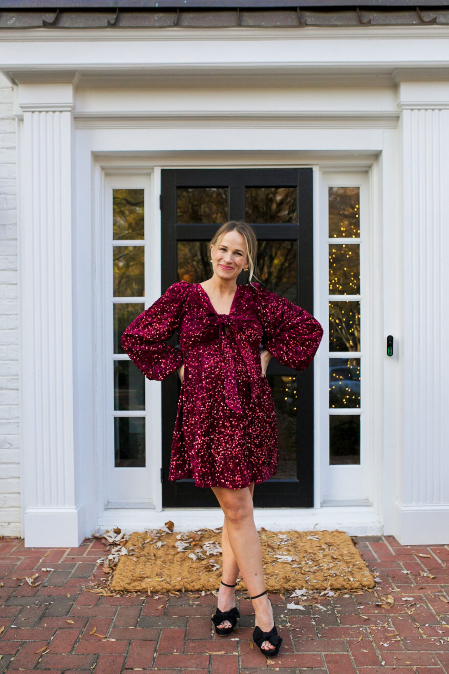 TeriLyn Adams wearing Burgundy Sequin Velour Front Tie Maternity Mini Dress one of her Maternity Holiday Dresses