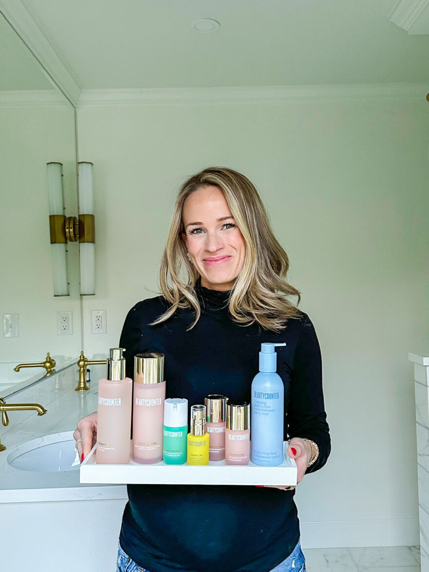  TeriLyn Adams at 8 months pregnant holding Beautycounter skincare products 