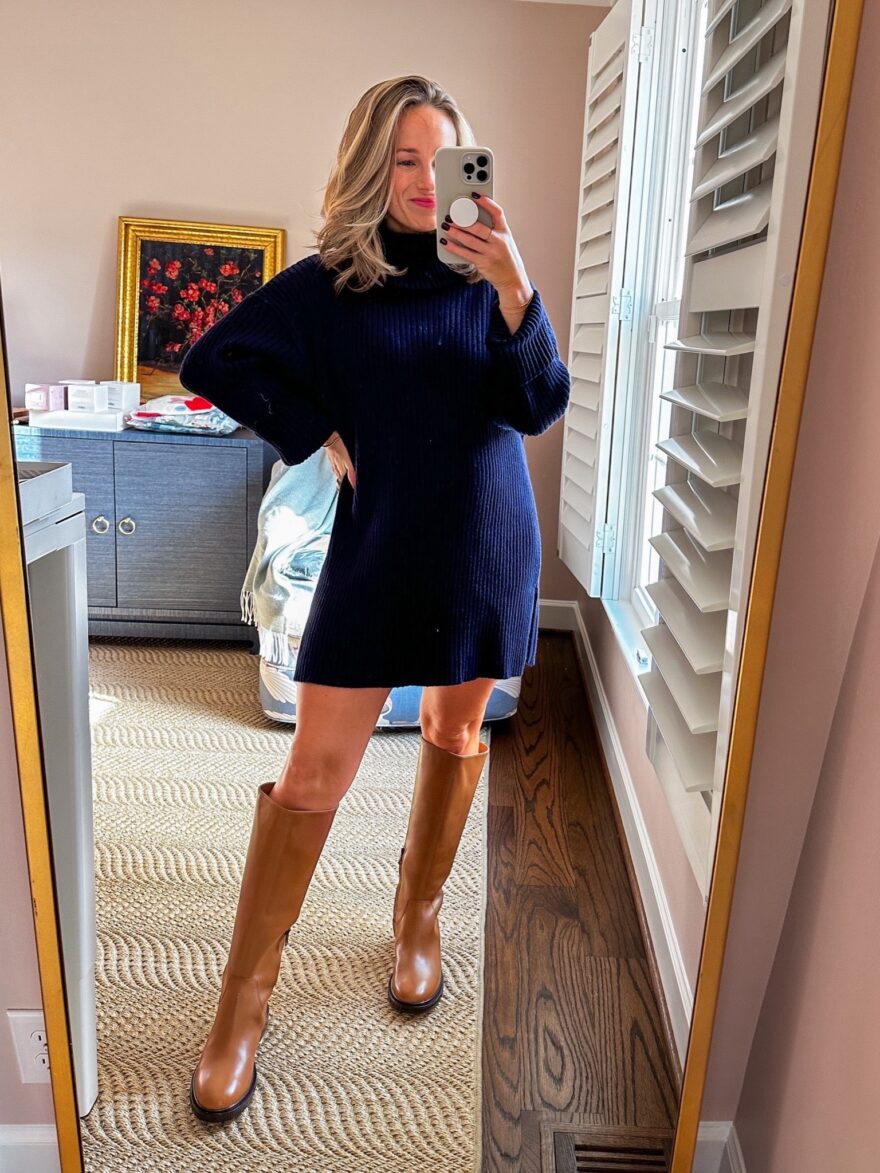 TeriLyn Adams in non-maternity maternity clothes, wearing a navy blue turtleneck sweater dress in her second trimester