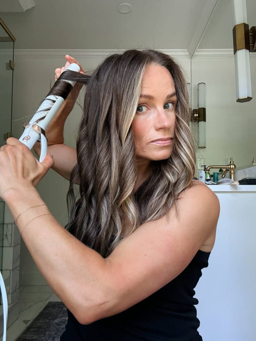 TeriLyn Adams using t3 curling iron to curl her hair