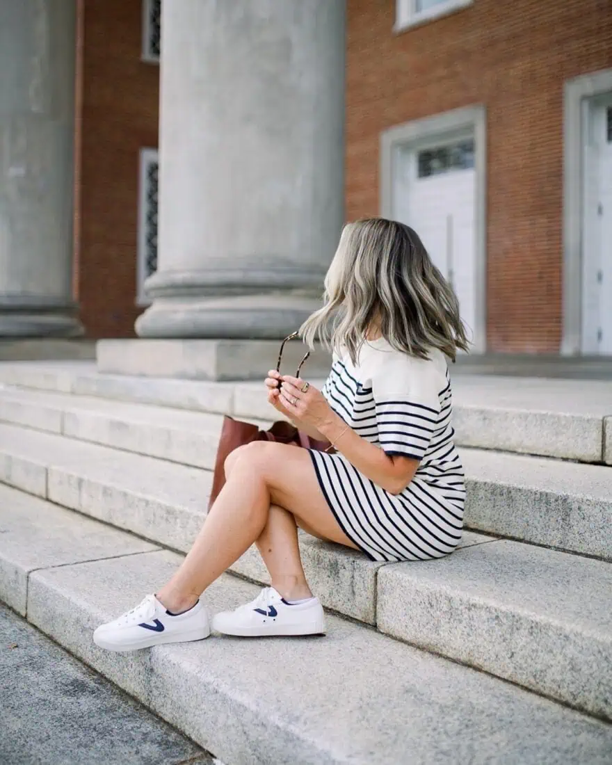 Woman showing what sneakers to wear with dresses: canvas sneakers