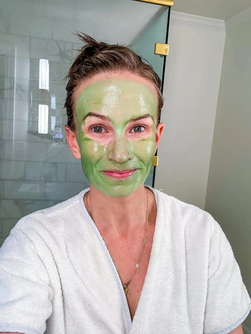 Woman with the Oliveda Honey Enzyme Face Mask on her face showing it applies green