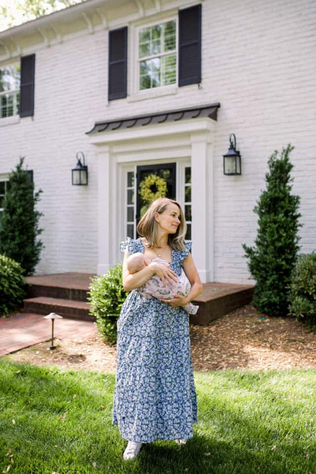 Woman holding baby in Nap dress