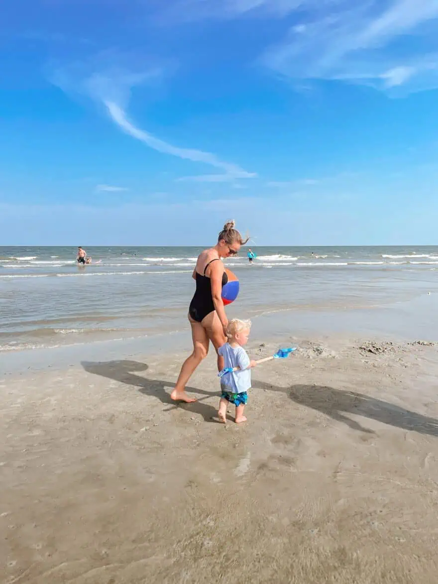 Woman at the beach with son wearing Island Goddess One-Piece Swimsuit 