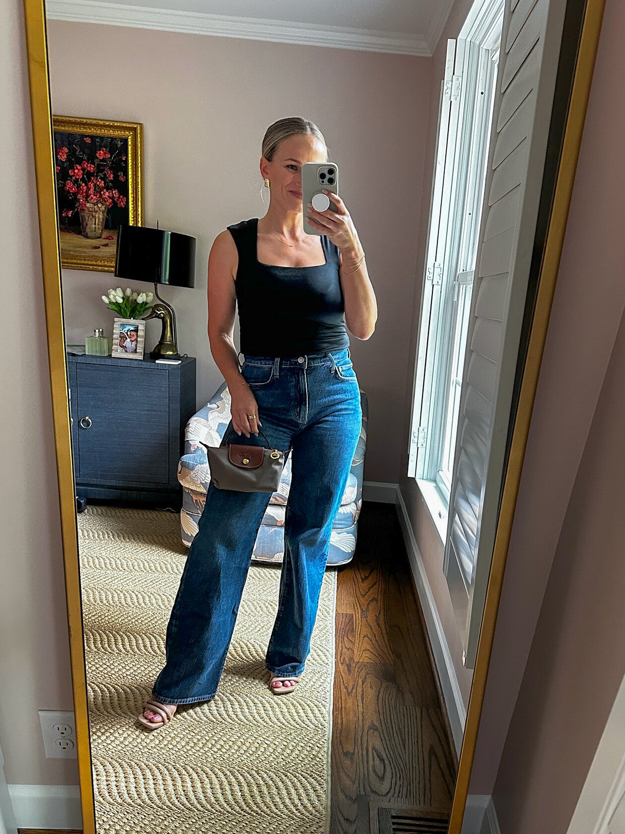 Woman showing how to style wide-leg jeans with heels