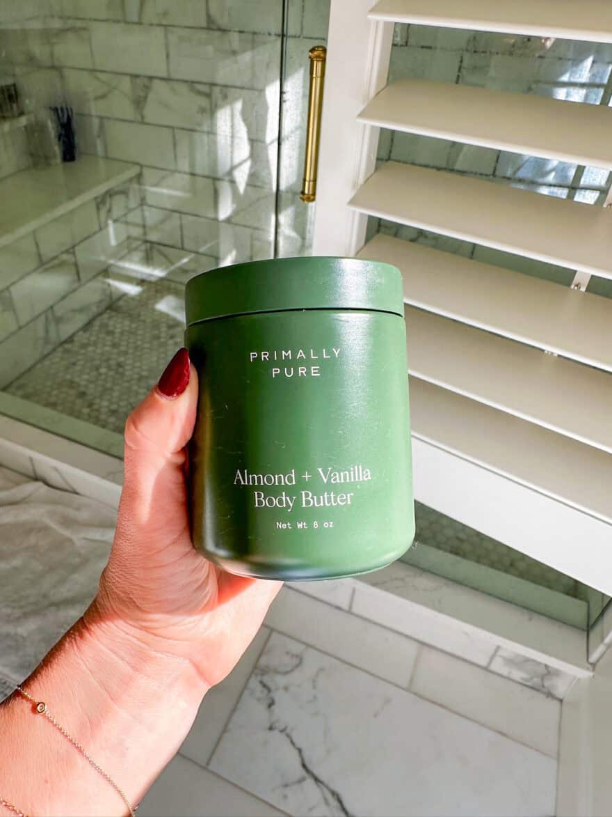 Woman holding jar of Primally Pure Almond+Vanilla body butter