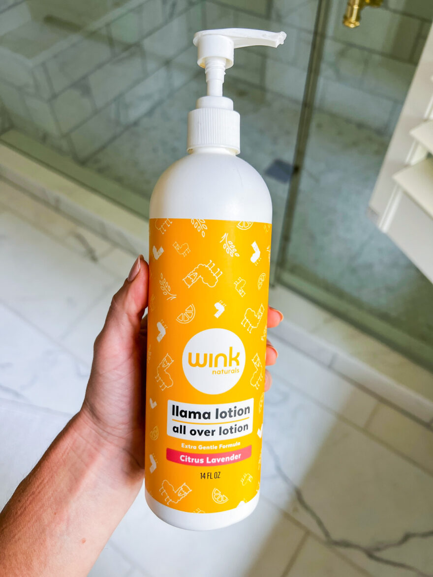 Woman holding Wink naturals llama lotion