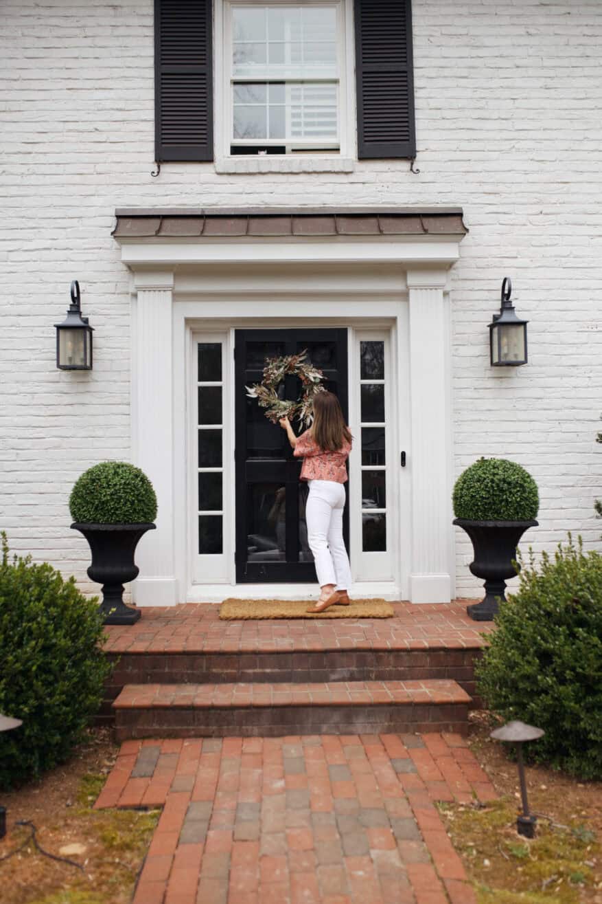 Woman decorating front porch