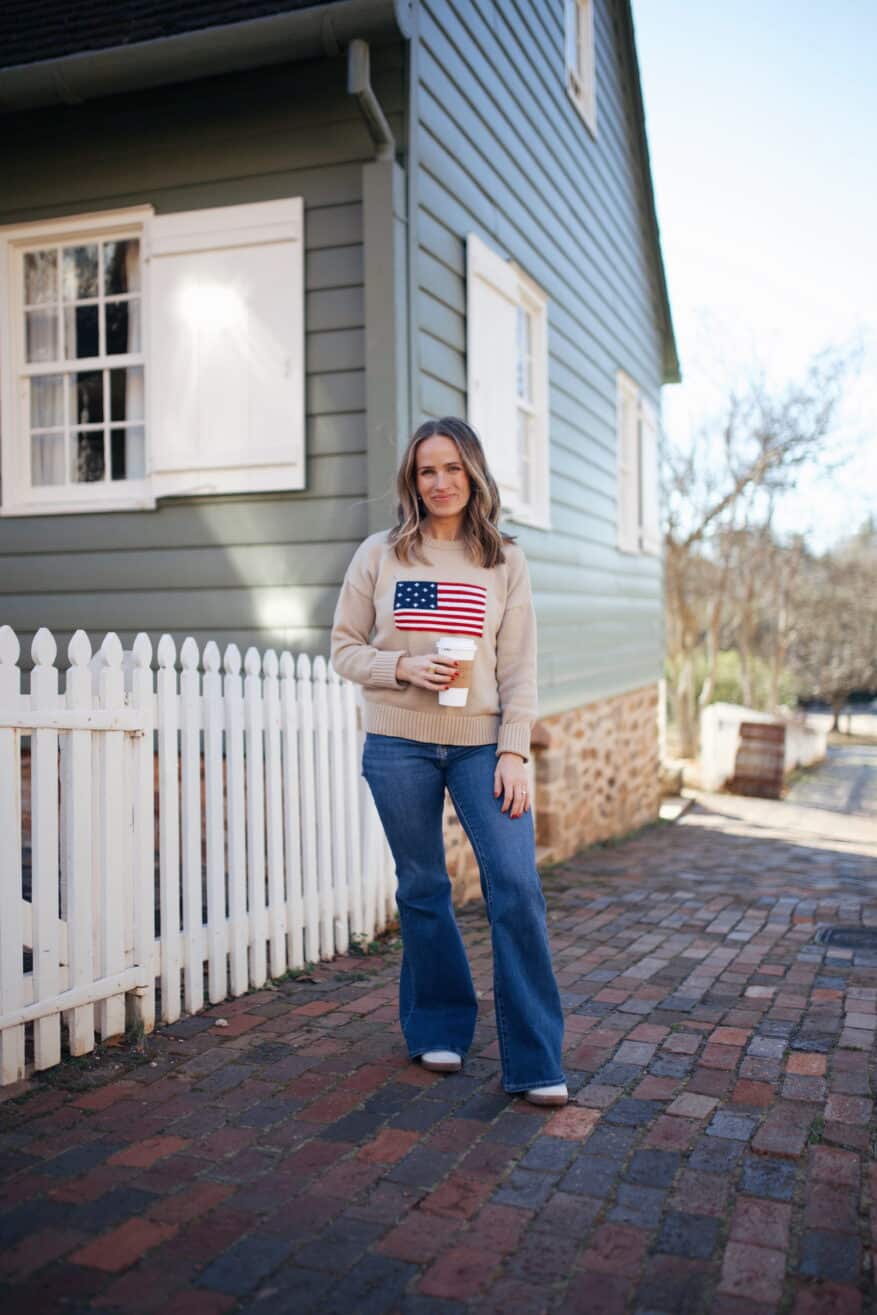Woman posing for picture in flare jeans