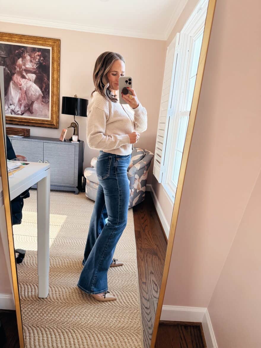 Woman wearing flare jeans with Stuart Weitzman ballet flats