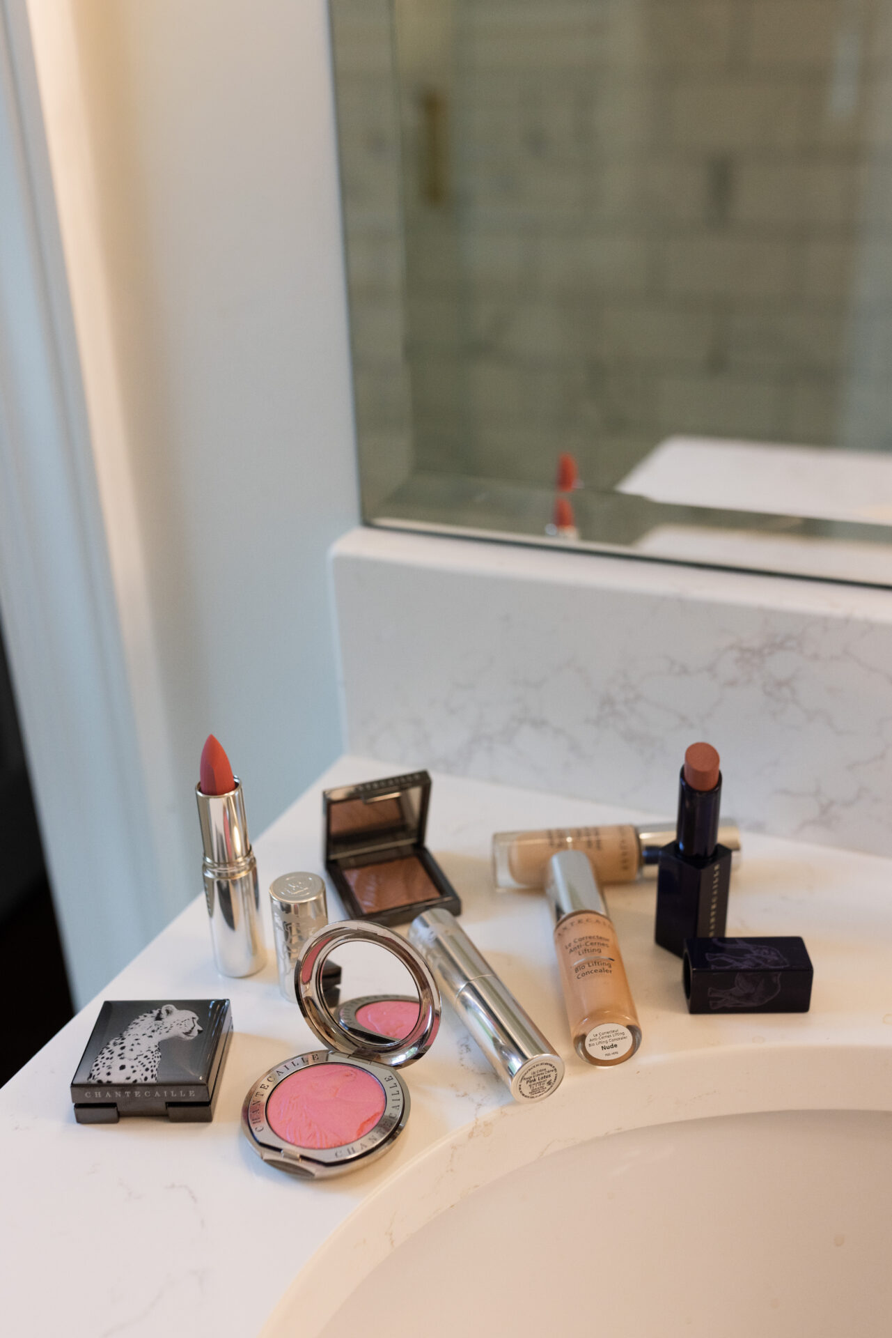 Chantecaille makeup collection including concealer, lipsticks, blush, and bronzer