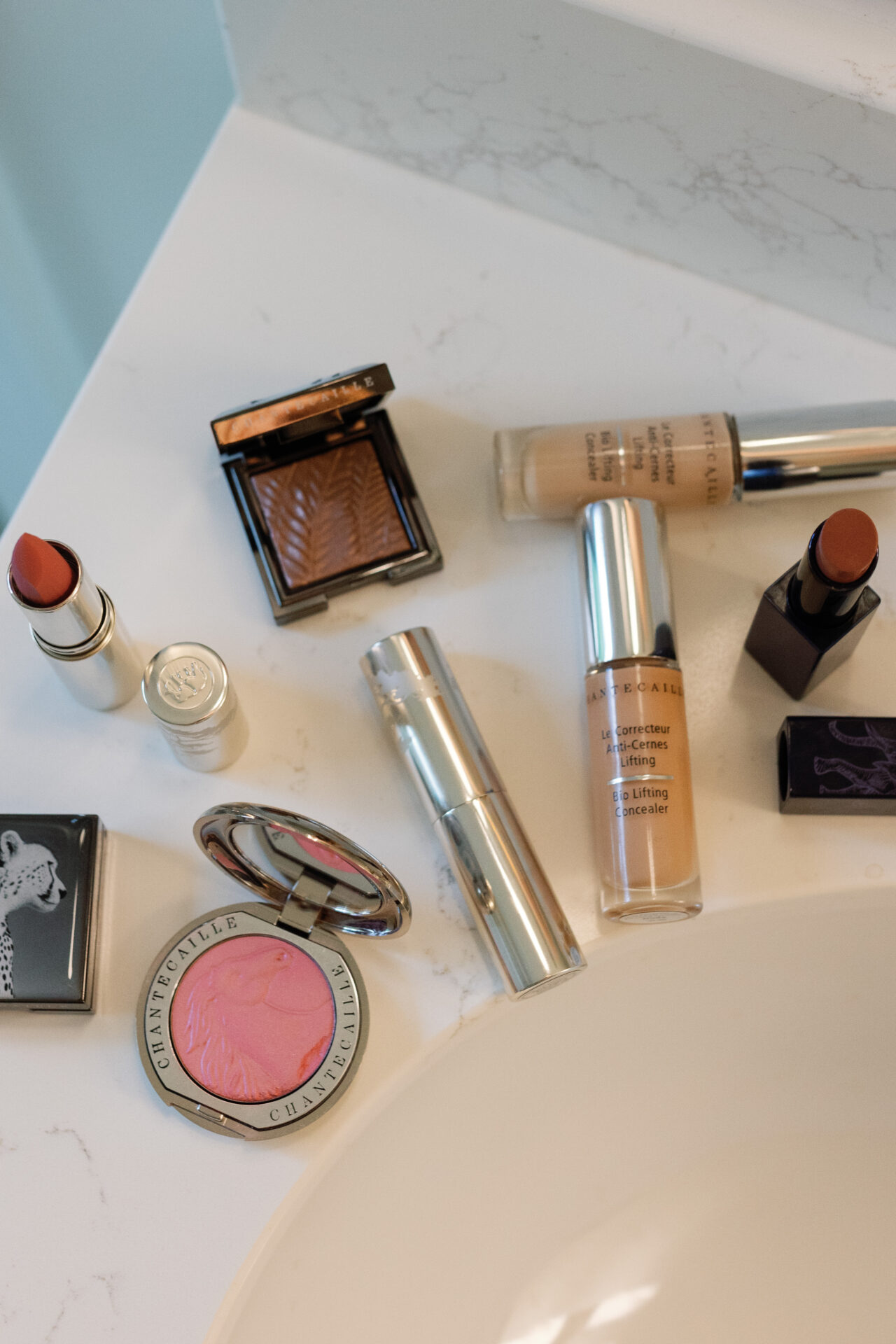 Overhead view of Chantecaille lipstick, blush, bronzer, and Bio Lifting Concealer