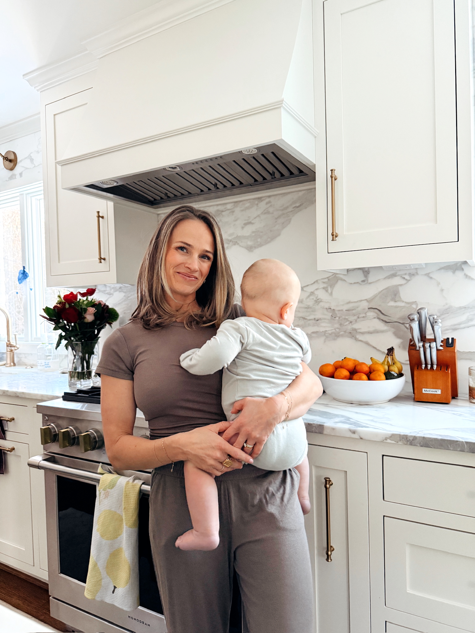 Woman wearing Nuuds Slinky Rib Wide-Leg Pant and Top while holding baby