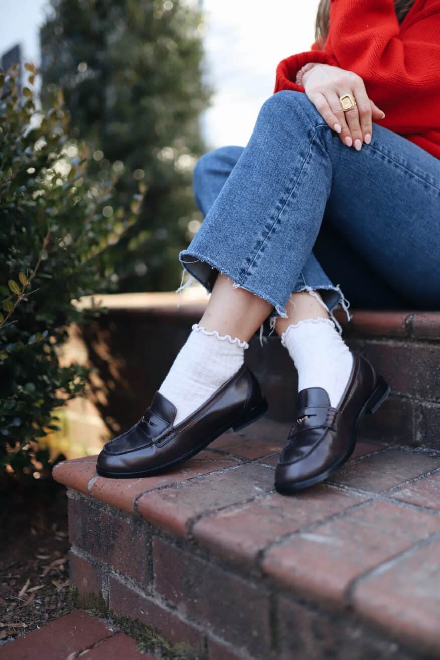 Woman wearing loafers with ruffle socks