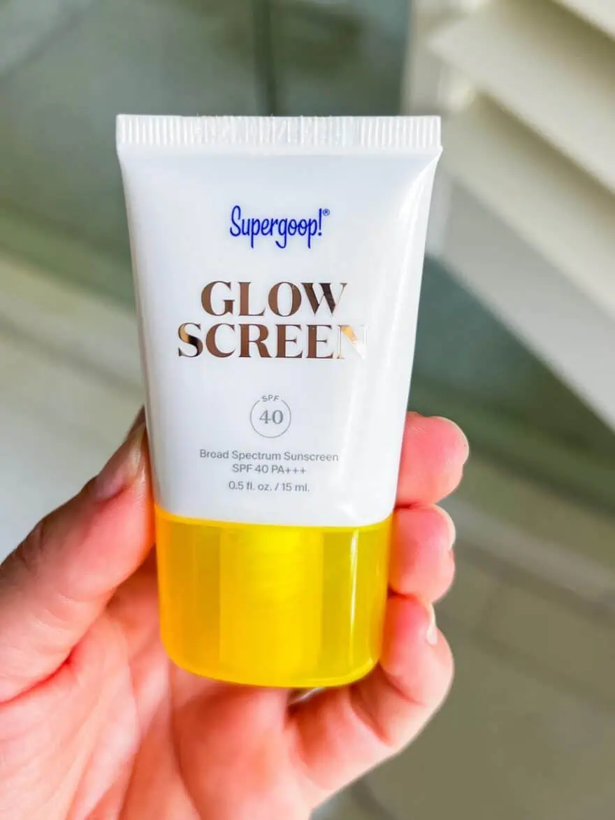 Woman holding Supergoop! Glowscreen SPF 40