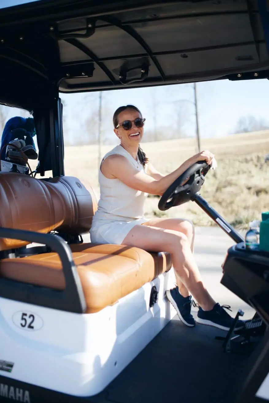 Woman driving golf cart in A. Putnam Crochet Sleeveless Top