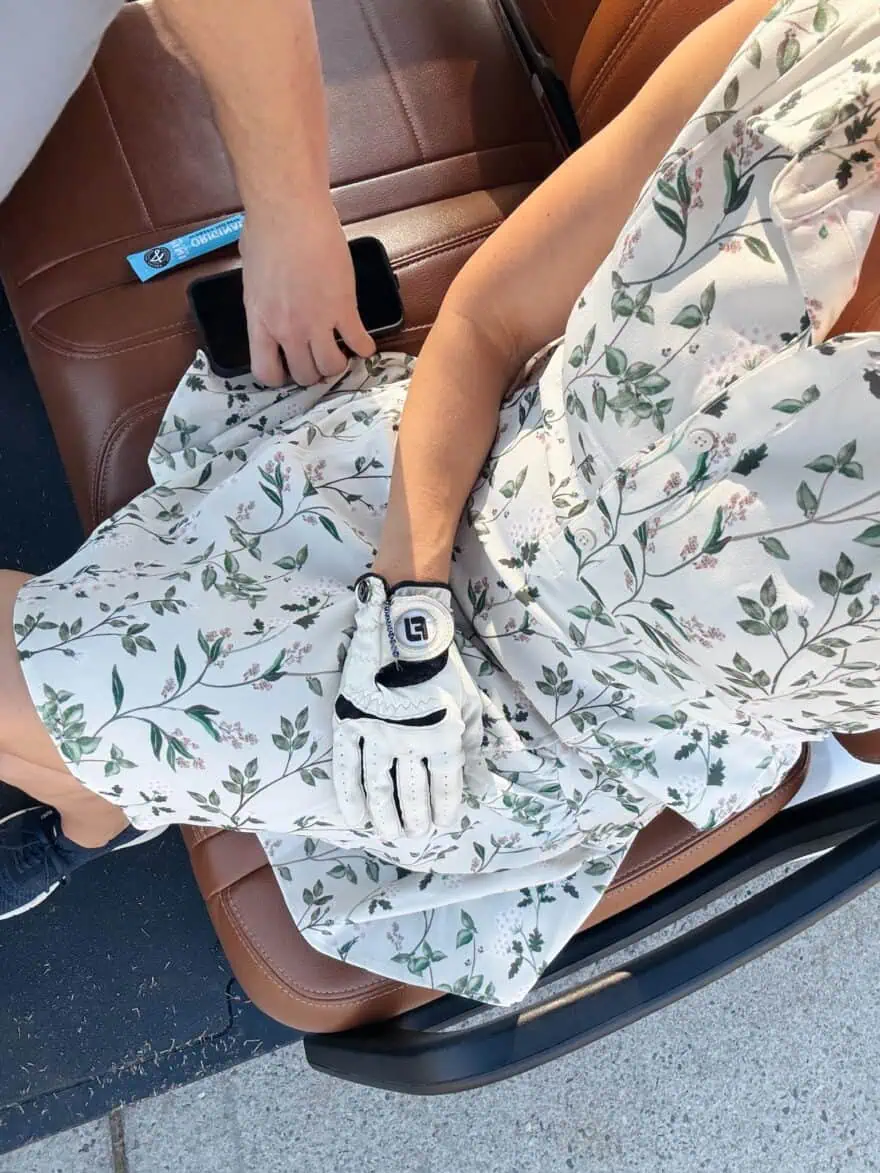 Woman riding on a golf cart in A. Putnam Garden Dress