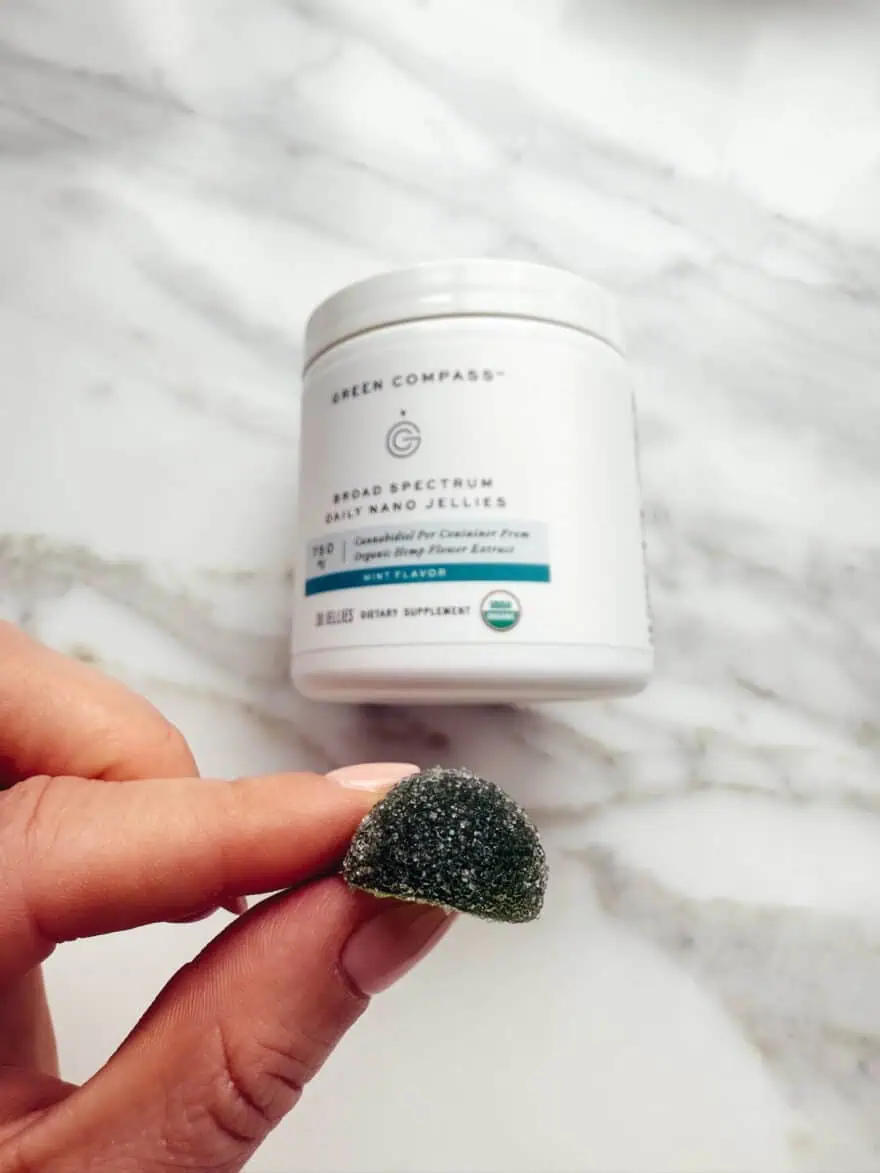 Woman holding Green Compass gummy