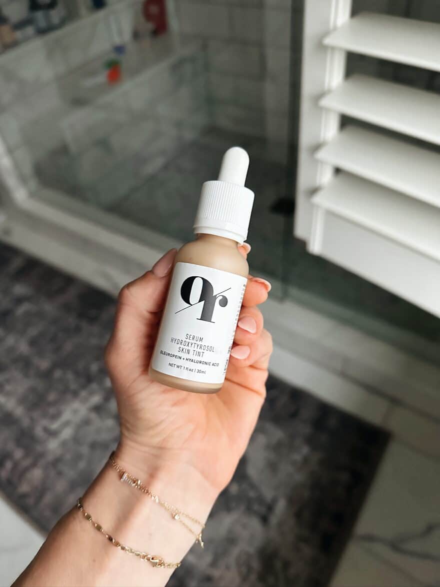 Woman holding Olive Rose Tinted Moisturizer