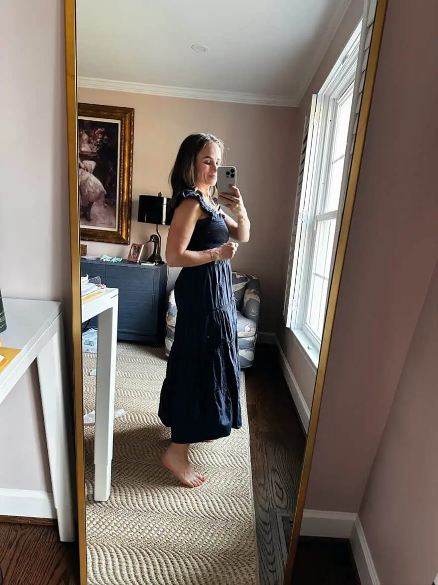 Woman showing side view of Quince Organic Cotton Poplin Smocked Midi Dress