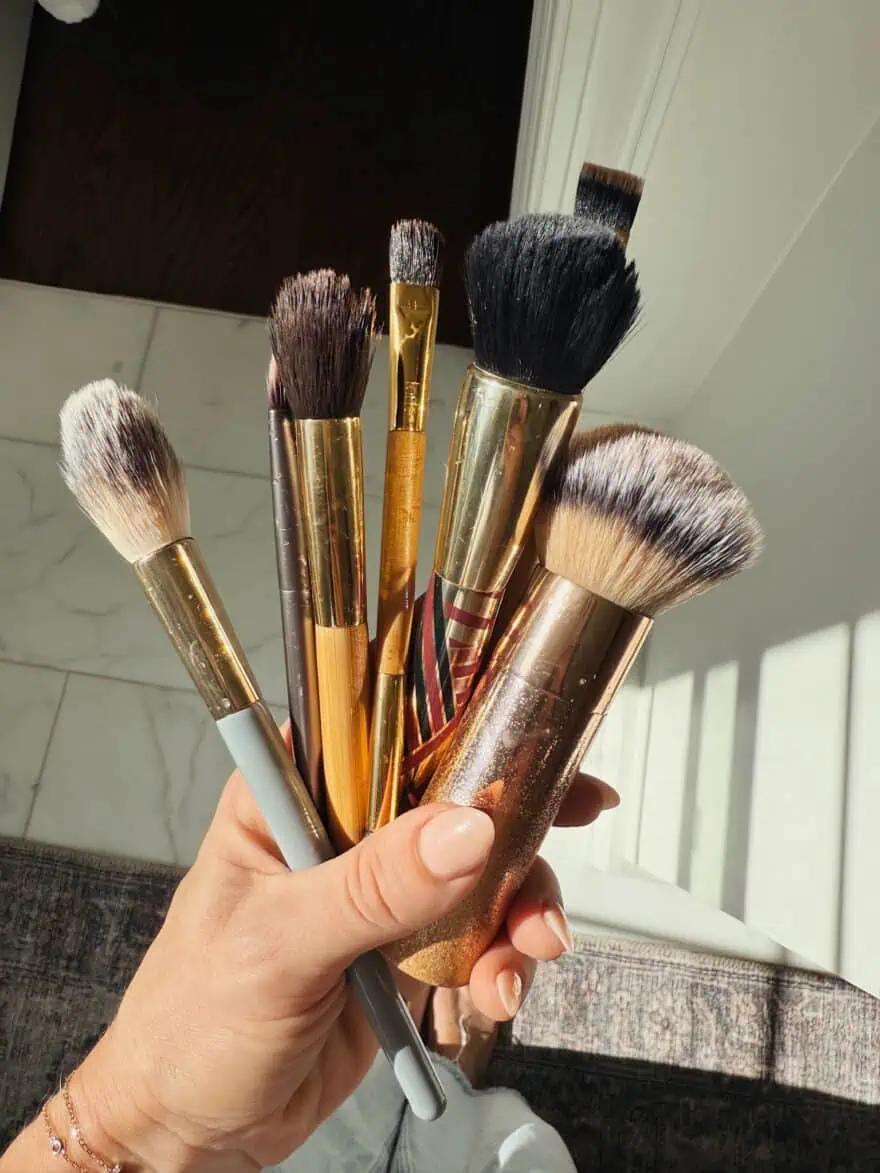 Woman showing clean make-up brushes
