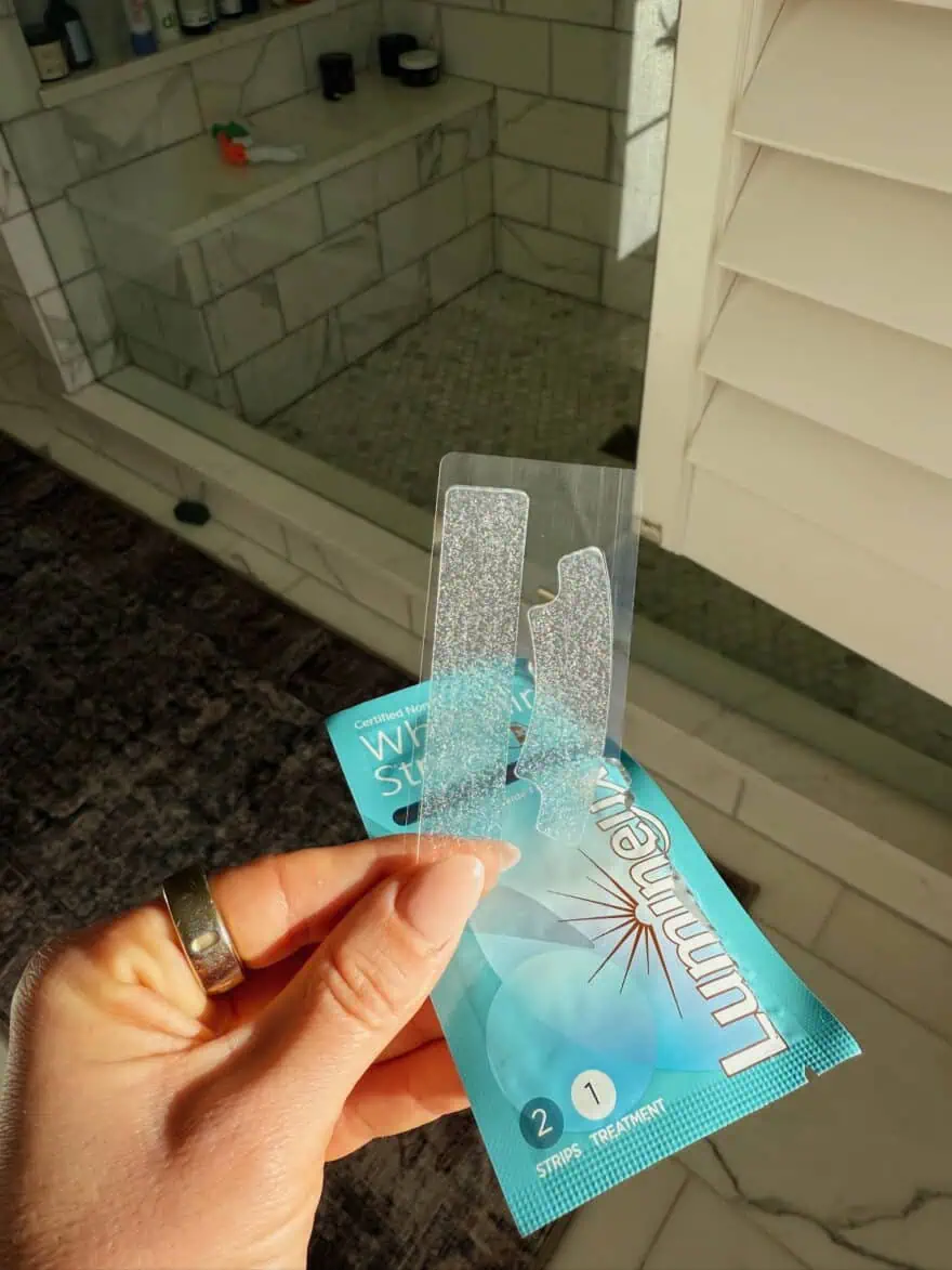 Woman holding Luminex Teeth Whitening Strips