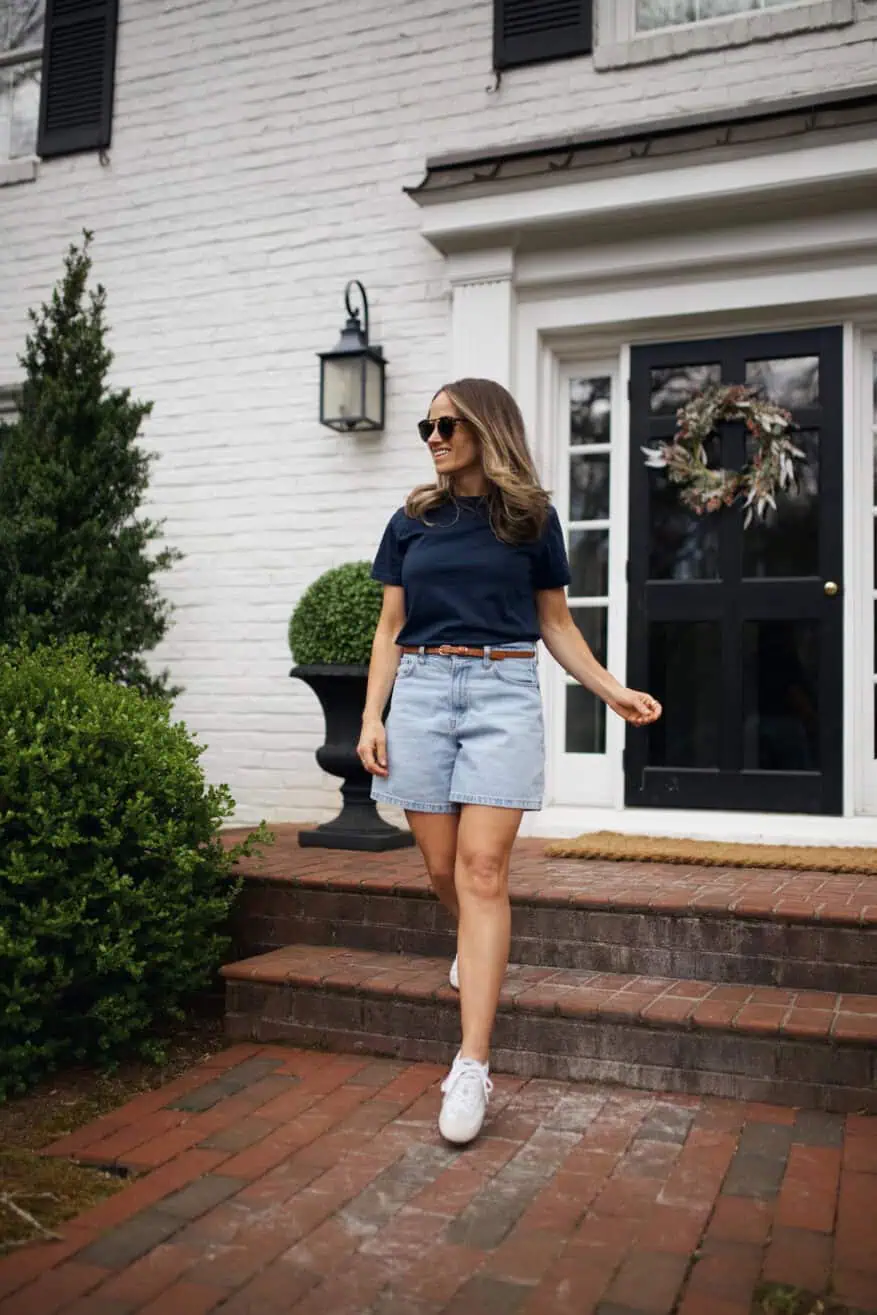 Woman wearing Abercrombie denim shorts with blue t-shirt and white sneakers