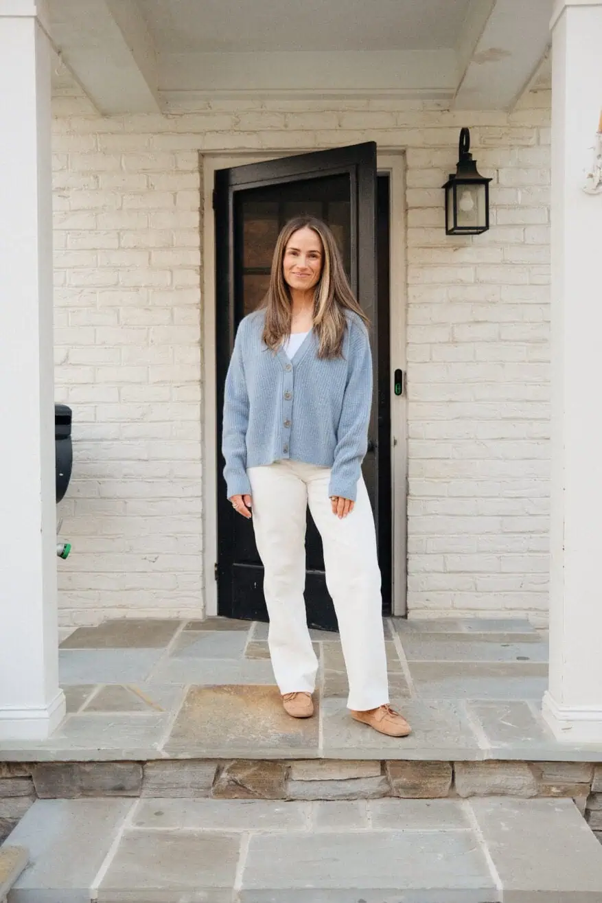 Woman wearing high rise straight leg jeans with blue sweater