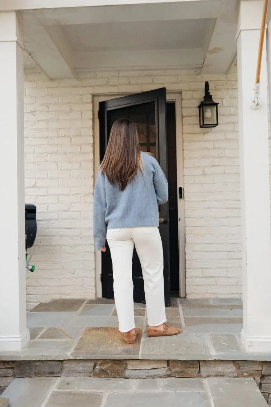 Woman showing back view of white straight ankle jeans
