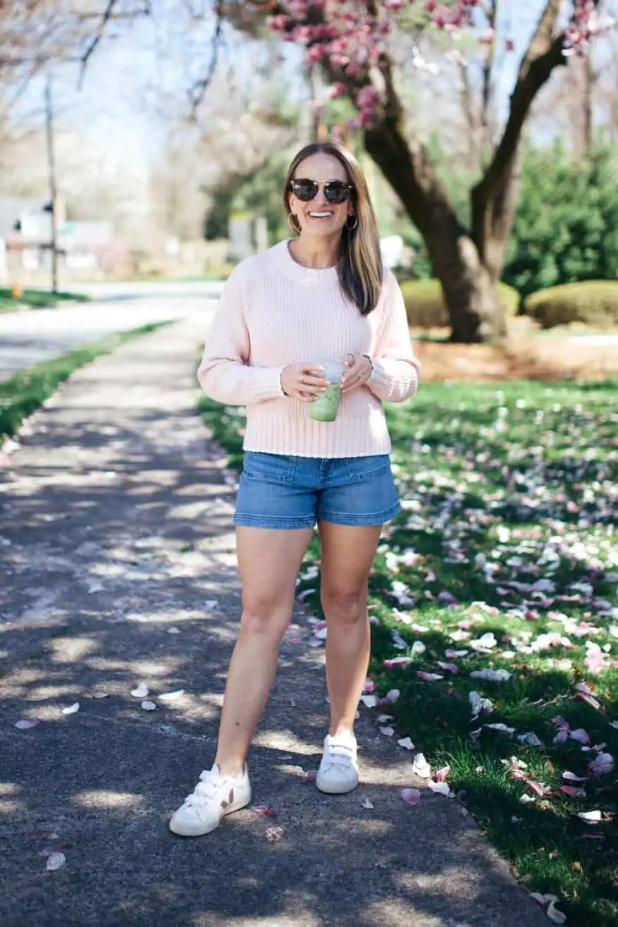 Woman wearing Madewell denim and pink sweater