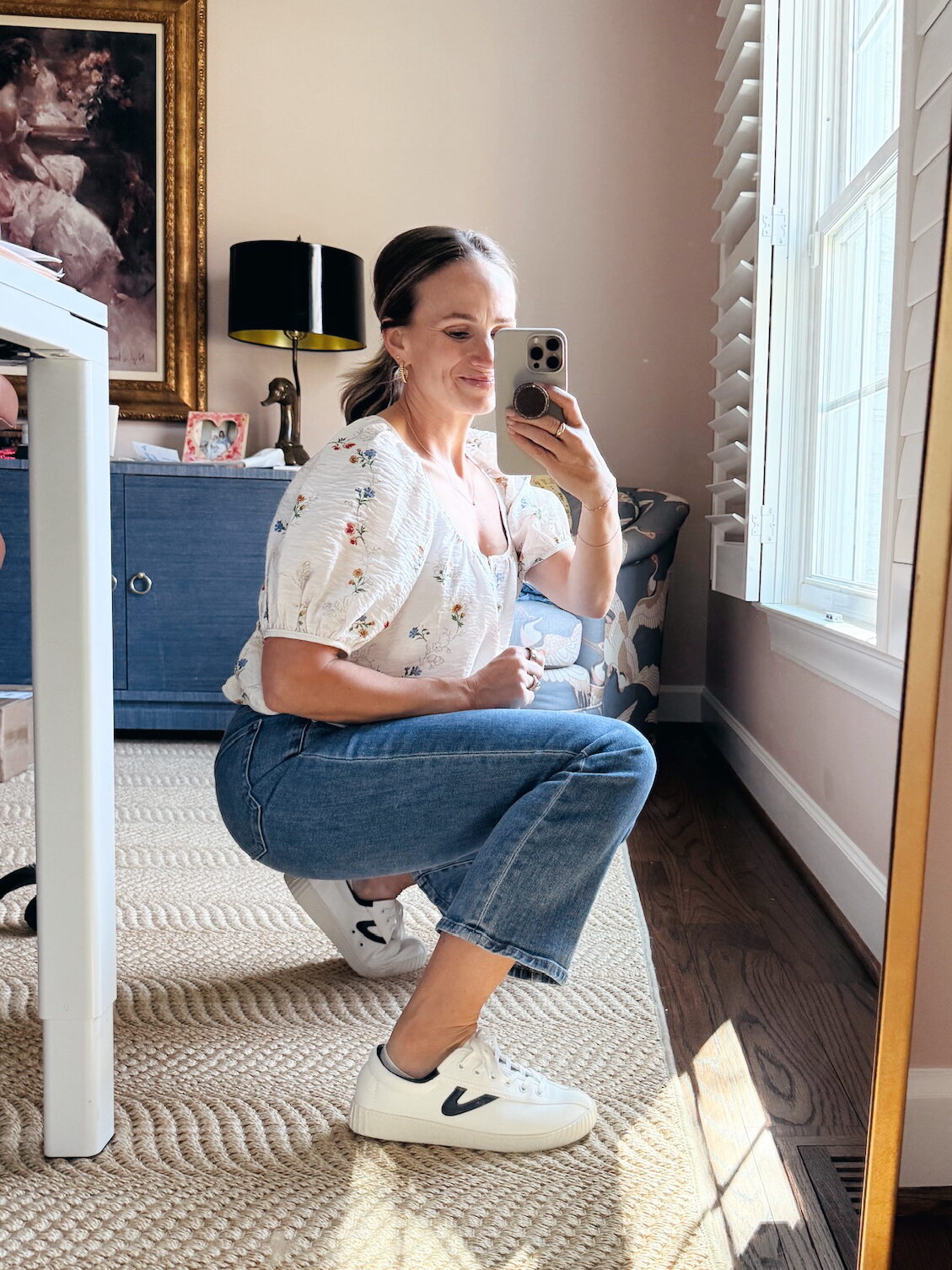 Woman showing side view of Tretorn Nylite white sneakers