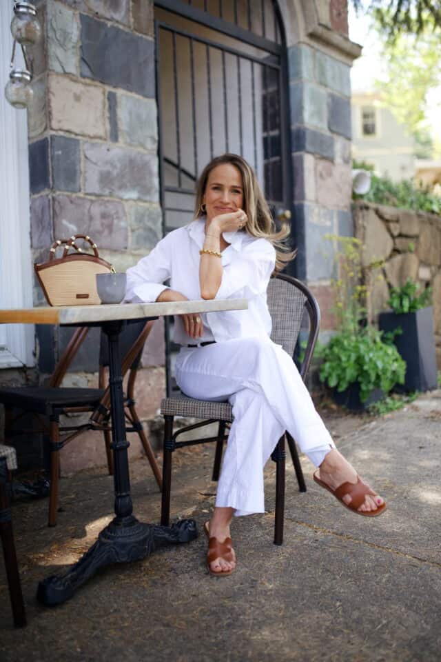 Woman wearing white top and pants by Frank & Eileen