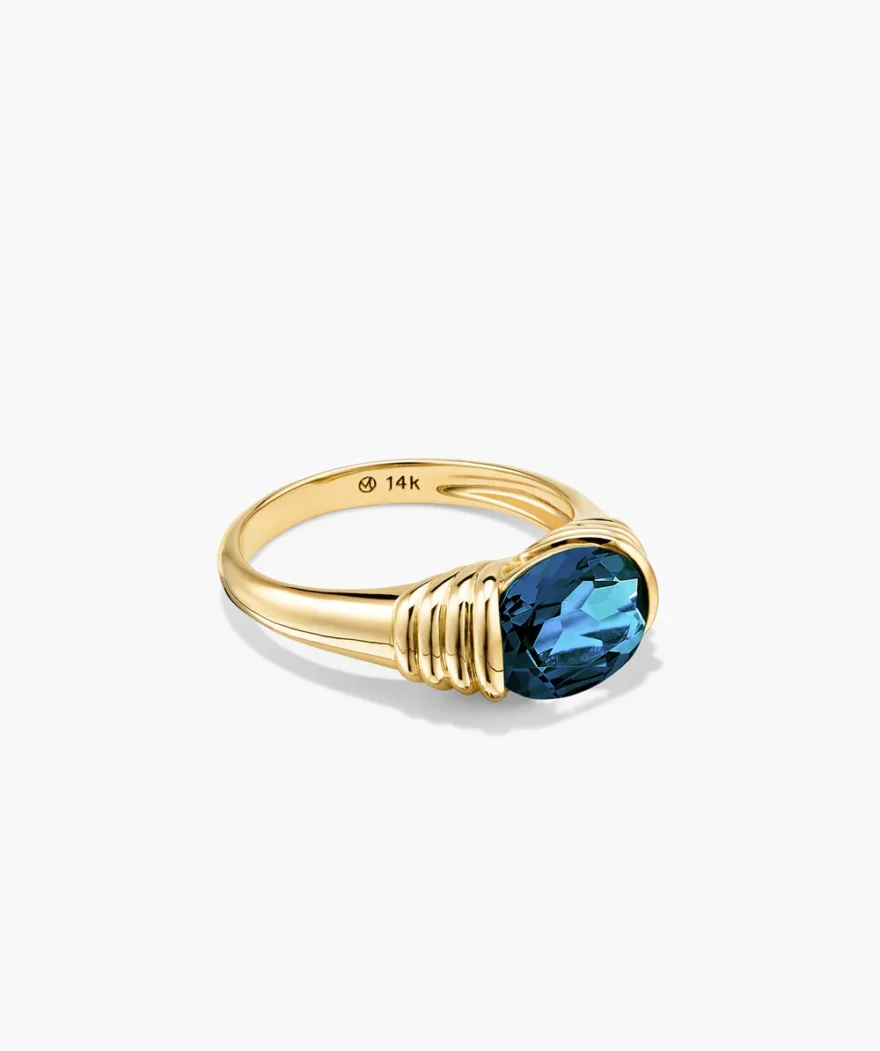 Mejuri Heirloom Ring with oval London Blue Topaz stone set in 14k gold ribbed bezel setting