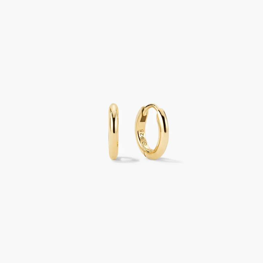 Mejuri Tube Huggie Hoops 12mm in gold with smooth rounded tube silhouette, Mejuri 925 stamp inside