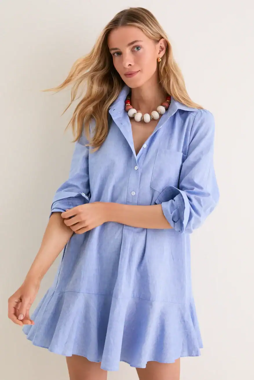 woman wearing chambray shirtdress and rolling up her sleeves